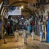 A worker in a protective suit sprays disinfectant at Grand Bazaar, known as the Covered Bazaar, to prevent the spread of coronavirus disease, in Istanbul, Turkey