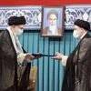 In this file photo, released by an official website of the office of the Iranian supreme leader, Supreme Leader Ayatollah Ali Khamenei, left, gives his official seal of approval to newly elected President Ebrahim Raisi (AP Photo)
