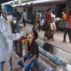 A health worker takes swab sample of a passenger to test for Covid-19 test at the Dadar railway station in Mumbai, Thursday, Aug. 5, 2021. (PTI Photo/Shashank Parade)