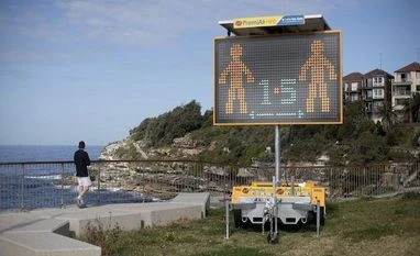 Covid-19: Sydney opens to vaccinated after 100-plus days of lockdown A social distancing sign at Bondi Beach in Sydney, Australia, on Monday, Aug. 2, 2021. Sydney's lockdown has been extended three times times and there is a risk it won't be lifted as currently scheduled on Aug. 28, given delta's continued spread and