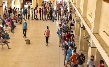 NCW asks states to take measures to bridge gender gap in Covid vaccination Visitors wait to get their dose of Covid-19 vaccine at an inoculation centre in Bikaner, Sunday, Aug. 8, 2021. (PTI Photo)