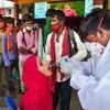 A health worker at a railway station in Bengaluru tests a passenger for Covid-19 on Monday, Aug. 9, 2021. (PTI Photo/ Shailendra Bhojak)