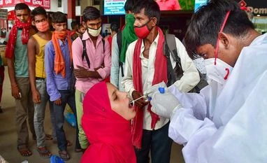With caseload in some districts still high, Andhra extends Covid curfew A health worker at a railway station in Bengaluru tests a passenger for Covid-19 on Monday, Aug. 9, 2021. (PTI Photo/ Shailendra Bhojak)