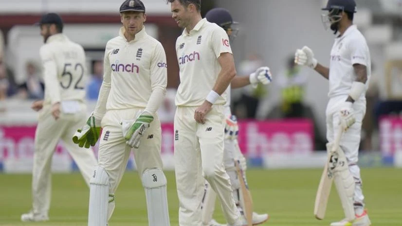England cricket team England's bowler James Anderson, right, speaks to England's Jos Buttler after completing an over during the 2nd cricket test between England and India at Lord's cricket ground in London, Thursday, Aug. 12, 2021. (AP Photo)