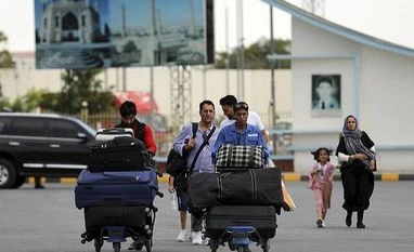 To keep Afghanistan connected, NATO to maintain operations at Kabul airport Passengers walk to the departures terminal of Hamid Karzai International Airport in Kabul, Afghanistan, Saturday, Aug. 14, 2021.