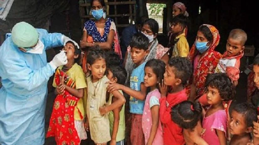 A health worker testing for Covid-19 collects swab samples from children who live in a slum Kolkata Monday, Sept. 6, 2021. (PTI photo.) A health worker testing for Covid-19 collects swab samples from children who live in a slum Kolkata Monday, Sept. 6, 2021. (PTI photo.)