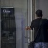 A pedestrian opens a door to a Chivo Bitcoin ATM booth at Gerardo Barrios plaza in San Salvador, El Salvador