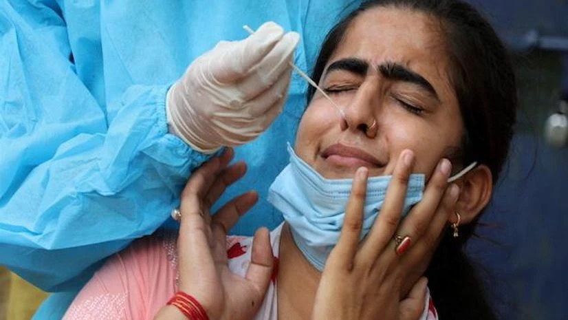 A health worker takes the swab sample of a woman to test for Covid-19 in Jammu on September 7, 2021. (PTI Photo) A health worker takes the swab sample of a woman to test for Covid-19 in Jammu on September 7, 2021. (PTI Photo)