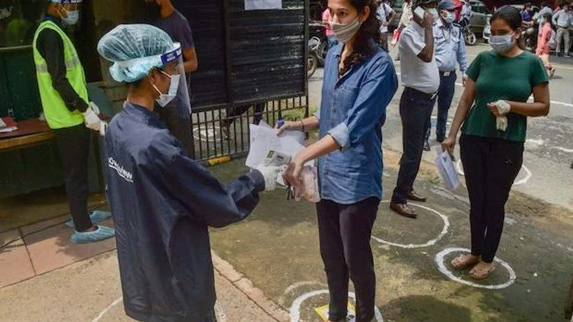 Candidates undergo thermal screening to check their temperatures before they write the National Eligibility cum Entrance Test (NEET), which selects students for India's state-run medical colleges, at an examination centre in Delhi on September 12, 20 Candidates undergo thermal screening to check their temperatures before they write the National Eligibility cum Entrance Test (NEET), which selects students for India’s state-run medical colleges, at an examination centre in Delhi on September 12, 20