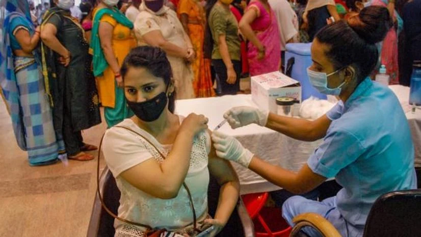 vaccine A health worker administers a dose of COVID-19 vaccine to a beneficiary, at a district hospital in Noida (Photo: PTI)