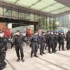 Security personnel form a human chain as they guard outside the Evergrande's headquarters, where people gathered to demand repayment of loans and financial products. (Photo: Reuters)