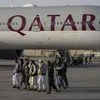 Taliban fighters walk past a Qatar Airways aircraft at the airport in Kabul, Afghanistan, September 9, 2021. (Photo: AP)