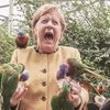 German Chancellor Angela Merkel’s shots of feeding a group of rainbow lorikeets — a species of parrot native to Australia —  at a bird park have gone viral. (Picture: Twitter)