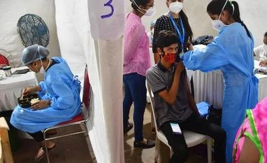 Covid LIVE: 53.5% in 18-44 age group vaccinated in India, says govt A health worker gives a visitor a Covid-19 vaccine shot at a health centre at the Parel Railway Workshop, in Mumbai on September 24, 2021. (PTI Photo)