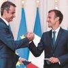 Greek Prime Minister Kyriakos Mitsotakis (left) and French President Emmanuel Macron shake hands after the signing of a new defence deal at The Elysee Palace on Tuesday. (Photo: AP)