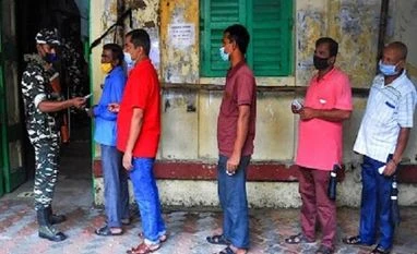 Violence mar KMC polls as 36.78% voter turnout recorded till 1 p.m. A paramilitary jawan checks the voter slip of a voter at a polling station during voting for Bhabanipur Assembly bypolls, in Kolkata (Photo: PTI)