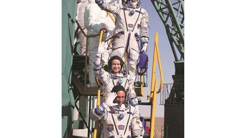 Russia space film n this handout photo released by the Roscosmos Space Agency, actress Yulia Peresild (centre) film director Klim Shipenko, (above) and cosmonaut Anton Shkaplerov wave prior to the launch to the International Space Station, ISS (Photo: AP/PTI)
