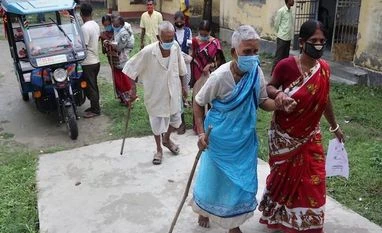India celebrates 1 bn Covid-19 vaccine doses with song, film, national flag Elderly visitors arrive at a government hospital near Balurghat in South Dinajpur district of West Bengal on October 19, 2021. (PTI Photo)
