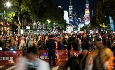 Country by country, scientists eye beginning of an end to Covid pandemic A New York Police Officer keeps an eye on revellers while they take part in the NYC Halloween Parade as the event returns to the streets of Lower Manhattan for the first time since the coronavirus disease outbreak in New York City (Photo: Reuters)