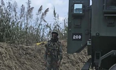 An Indian army soldier stands guard on a highway on the outskirts of Kohima, capital of northeastern Nagaland state, India, Sunday, Dec. 5, 2021. Angry villagers burned army vehicles in protest after more than a dozen people were killed by soldiers w An Indian army soldier stands guard on a highway on the outskirts of Kohima, capital of northeastern Nagaland state, India, Sunday, Dec. 5, 2021. Angry villagers burned army vehicles in protest after more than a dozen people were killed by soldiers w