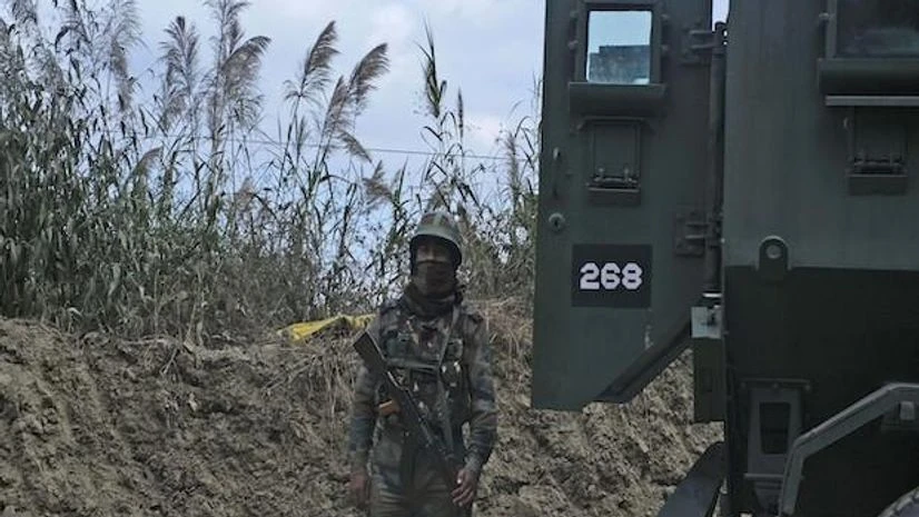 An Indian army soldier stands guard on a highway on the outskirts of Kohima, capital of northeastern Nagaland state, India, Sunday, Dec. 5, 2021. Angry villagers burned army vehicles in protest after more than a dozen people were killed by soldiers w An Indian army soldier stands guard on a highway on the outskirts of Kohima, capital of northeastern Nagaland state, India, Sunday, Dec. 5, 2021. Angry villagers burned army vehicles in protest after more than a dozen people were killed by soldiers w