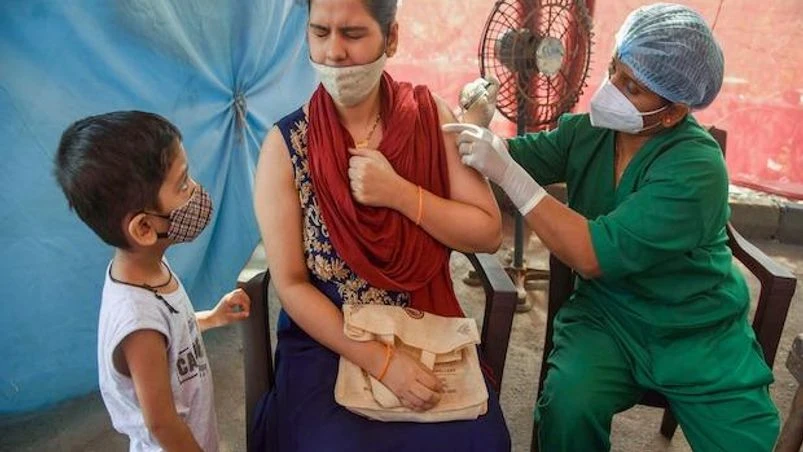 A visitor gets a dose of Covid-19 vaccine at an inoculation camp in Navi Mumbai on December 11, 2021. (PTI Photo) A visitor gets a dose of Covid-19 vaccine at an inoculation camp in Navi Mumbai on December 11, 2021. (PTI Photo)