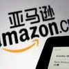 The sign of e-commerce website Amazon China is seen next to a Kindle e-reader displayed in this illustration (Reuters)