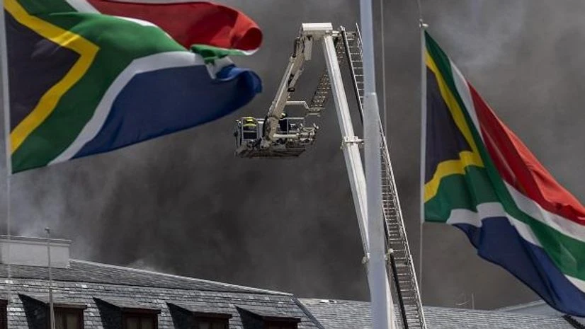 South Africa parliament fire Firemen spray water on flames erupting from a building at South Africa's Parliament in Cape Town Sunday Jan. 2, 2022. (AP Photo/Jerome Delay)