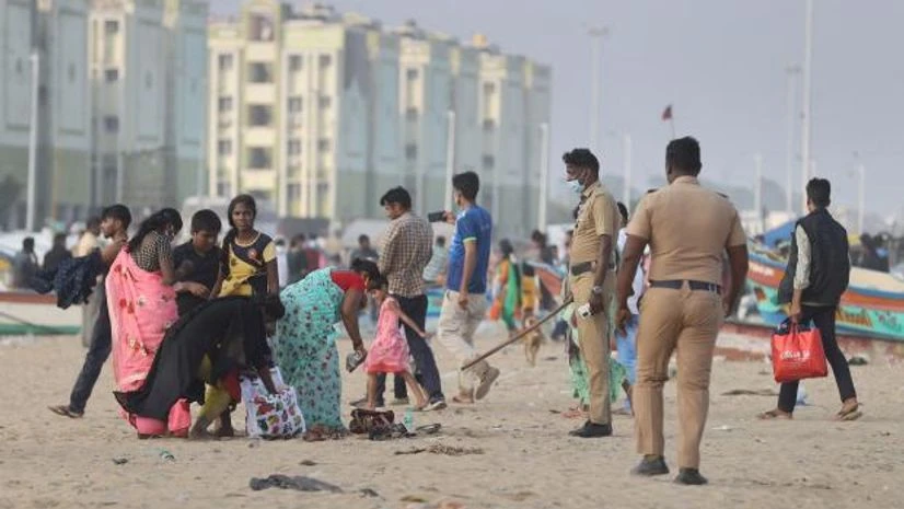 Marina beach Greater Chennai Corporation officials ask people not to sit on the Marina beach as authorities have allowed visitors to the beach for walking purposes only, following the sharp increase in Covid-19 infections in Chennai (Photo: PTI)