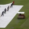 General view of groundstaff moving the rain cover as rain delays the start of the day's play (Photo: Reuters)