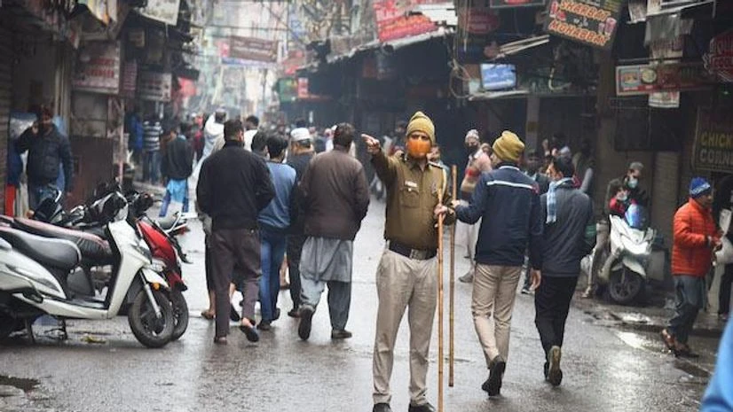 Covid, Delhi A policeman regulates movement of people during the weekend curfew imposed by the Delhi government to curb the spread of Covid-19, in New Delhi (Photo: PTI)