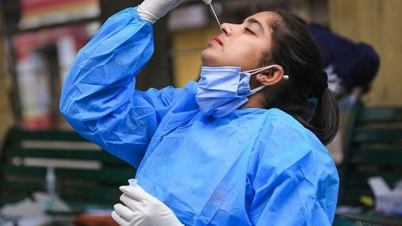 covid test jammu A health worker in Jammu takes her swab sample for a Covid-19 test on January 16, 2022. (PTI Photo)