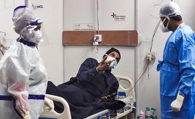 Most of recent Covid deaths in Delhi were of unvaccinated patients: Report Medical workers attend to a Covid-19 patient at a makeshift care centre in Delhi's Commonwealth Games (CWG) Village on January 20, 2022. (PTI Photo/Kamal Singh)