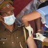 A health worker gives a police officer a dose of Covid-19 vaccine at the IIT-Madras campus in Chennai. (PTI Photo)