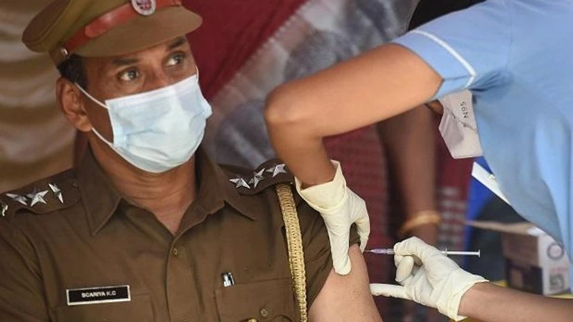coronavirus, covid A health worker gives a police officer a dose of Covid-19 vaccine at the IIT-Madras campus in Chennai. (PTI Photo)