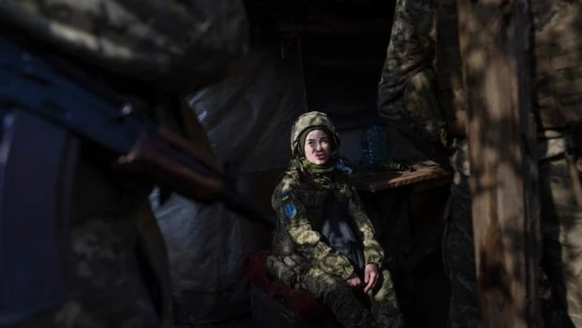 ukraine A Ukrainian soldier talks with her comrades sitting in a shelter at the line of separation between Ukraine-held territory and rebel-held territory near Svitlodarsk, eastern Ukraine, on February 23, 2022.