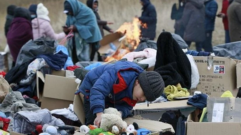 Ukraine russia A child collects toys near a clothes donating point as refugees fleeing conflict in Ukraine arrive at the Medyka border crossing in Poland (Photo: AP/PTI)