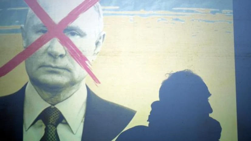 putin A man is silhouetted on a screen depicting Russia's President Vladimir Putin, during a rally against Russia's invasion of Ukraine, in Athens, Greece, Tuesday, March 1, 2022. (AP Photo/Thanassis Stavrakis)