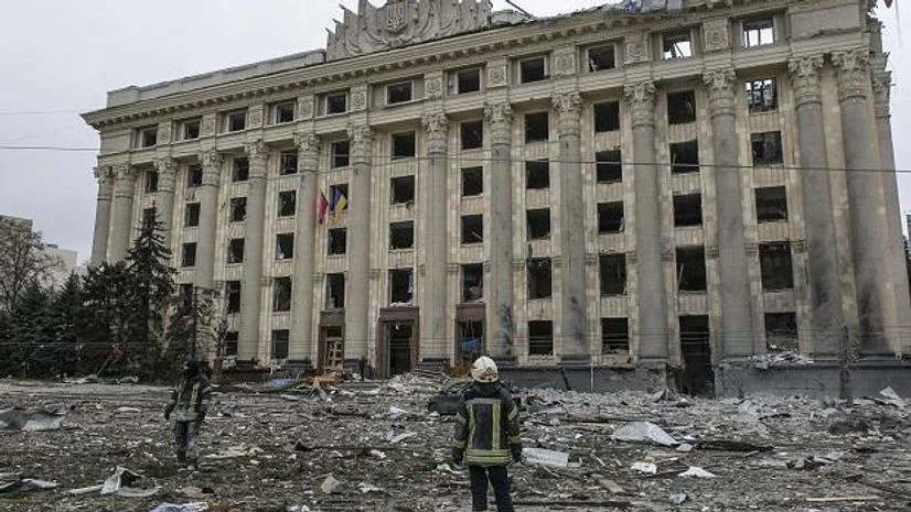 ukraine India A member of the Ukrainian Emergency Service looks at the City Hall building in the central square following shelling in Kharkiv (Photo: AP/PTI)