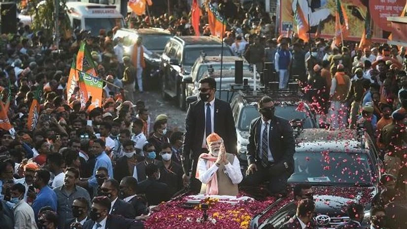 Modi, Narendra Modi Prime Minister Narendra Modi greets supporters during a roadshow for the seventh and last phase of UP Assembly elections, in Varanasi district (Photo: PTI)