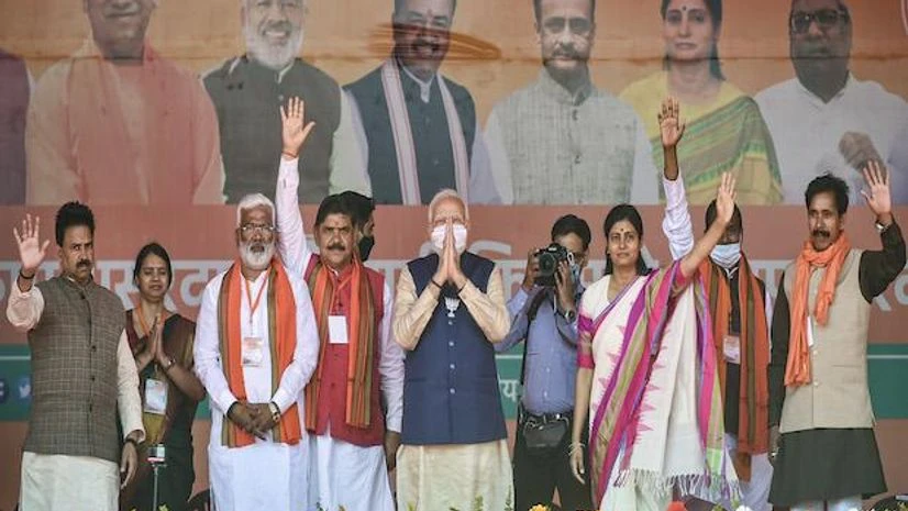 UP Polls, Narendra Modi Prime Minister Narendra Modi and BJP leaders greet the supporters during a public meeting for the seventh and last phase of UP Assembly elections at Khajuri village, in Varanasi (Photo: PTI)