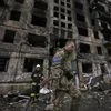 Ukrainian soldiers and firefighters search in a destroyed building after a bombing attack in Kyiv, Ukraine, Monday, March 14, 2022. (AP Photo/Vadim Ghirda)