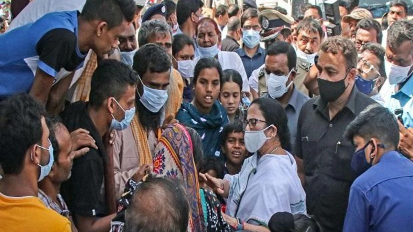 West Bengal Chief Minister Mamta Banerjee interacts with the family members of TMC leader Bhadu Sheikh, after his death, at his residence, in Birbhum (Photo: PTI) Mamta Banerjee