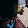 A boy uses a portable fan at the main door of a house during the power cut as many parts of the country currently face long power cuts, as currency shortage makes fuel scarce, in Colombo (Photo: Reuters)
