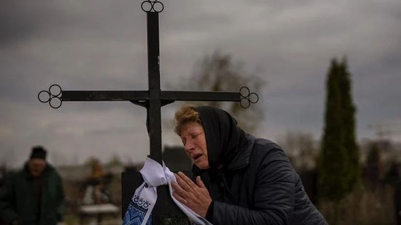 Russia Ukraine conflict Galyna Bondar mourns next to the grave of her son Oleksandr, 32, after burying him at the cemetery in Bucha, Ukraine on April 16, 2022. Oleksandr was killed by a gunshot by the Russian Army. (AP Photo/Emilio Morenatti)