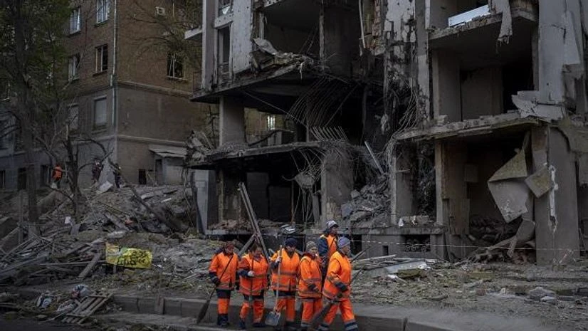 ukraine russia Clean-up crews prepare to work at the site of an explosion in Kyiv, Ukraine on Friday, April 29, 2022. (AP Photo/Emilio Morenatti)