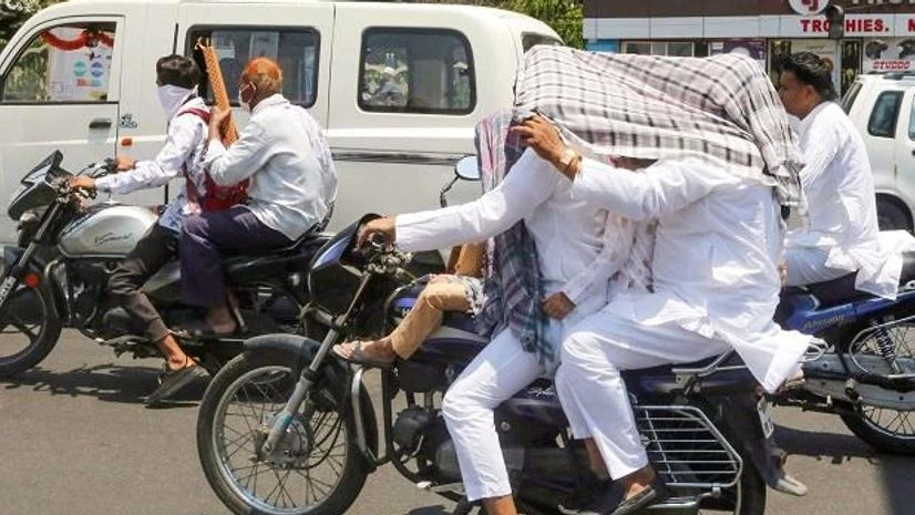 heat, summer, heatwave Motorists shield themselves from the sun. (PTI Photo)
