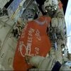 In this photo taken from video footage released by Roscosmos Space Agency, Roscosmos' cosmonauts Oleg Artemyev and Denis Matveev unfold a copy of the Soviet Victory Banner in World War II during their spacewalk on the International Space Station (ISS