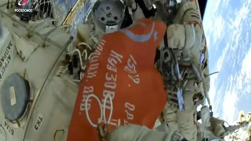 Russia space station In this photo taken from video footage released by Roscosmos Space Agency, Roscosmos' cosmonauts Oleg Artemyev and Denis Matveev unfold a copy of the Soviet Victory Banner in World War II during their spacewalk on the International Space Station (ISS