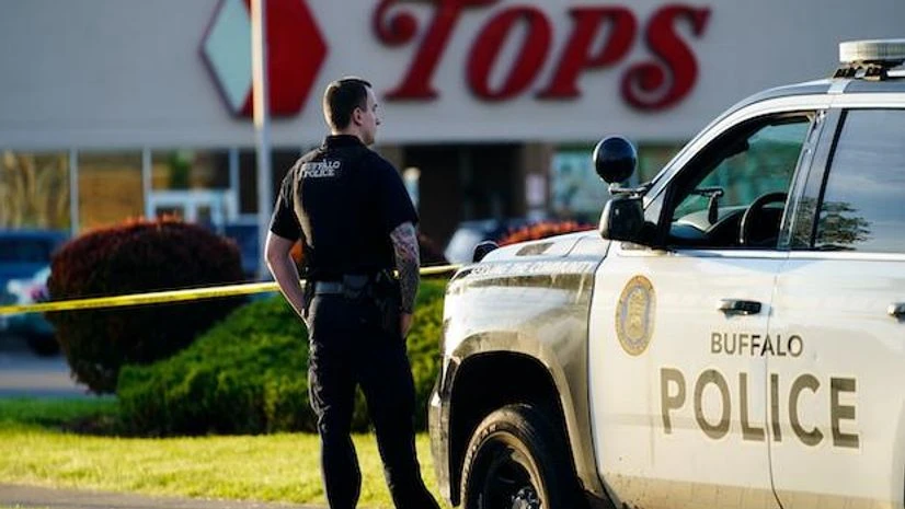 US shooting A police officer stands guard outside the scene of a shooting at a supermarket, in Buffalo, N.Y., Sunday, May 15, 2022. (AP Photo/Matt Rourke)